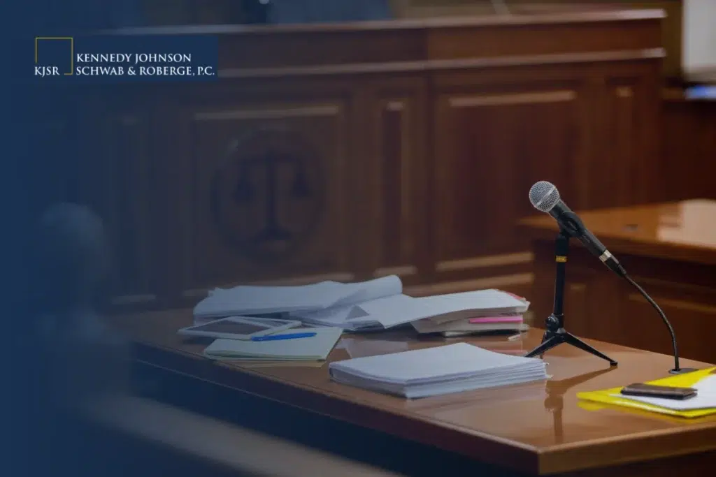 The Role of Expert Testimony in Medical Malpractice Cases. A desk in a courtroom with a microphone and papers scattered across the top