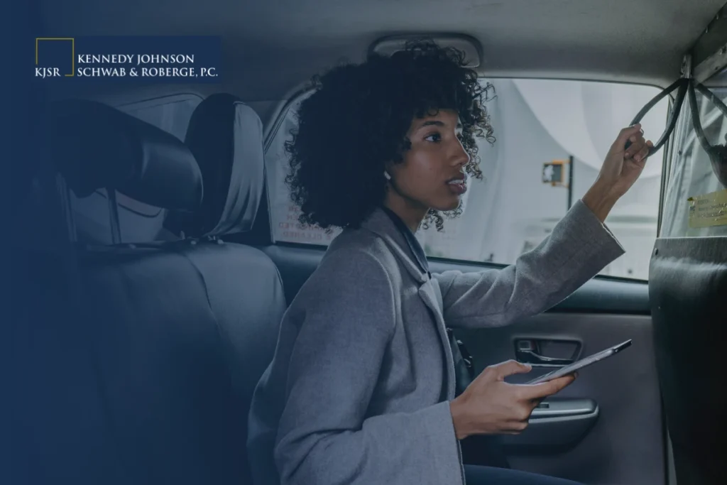 A woman looking ahead with a phone in her hand. What to do if you feel unsafe during a rideshare ride like Uber or Lyft.